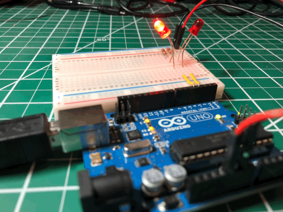 Top-down workbench animated gif of the circuit working with Arduino